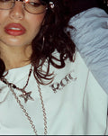 Close-up of the RAT logo printed on the white tee